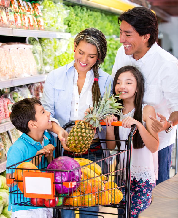 Happy family at the supermarket shopping for groceries