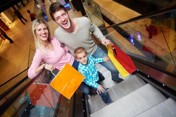 happy young family portrait in shopping mall