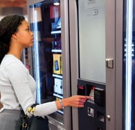 Vending machine being used inside a mall